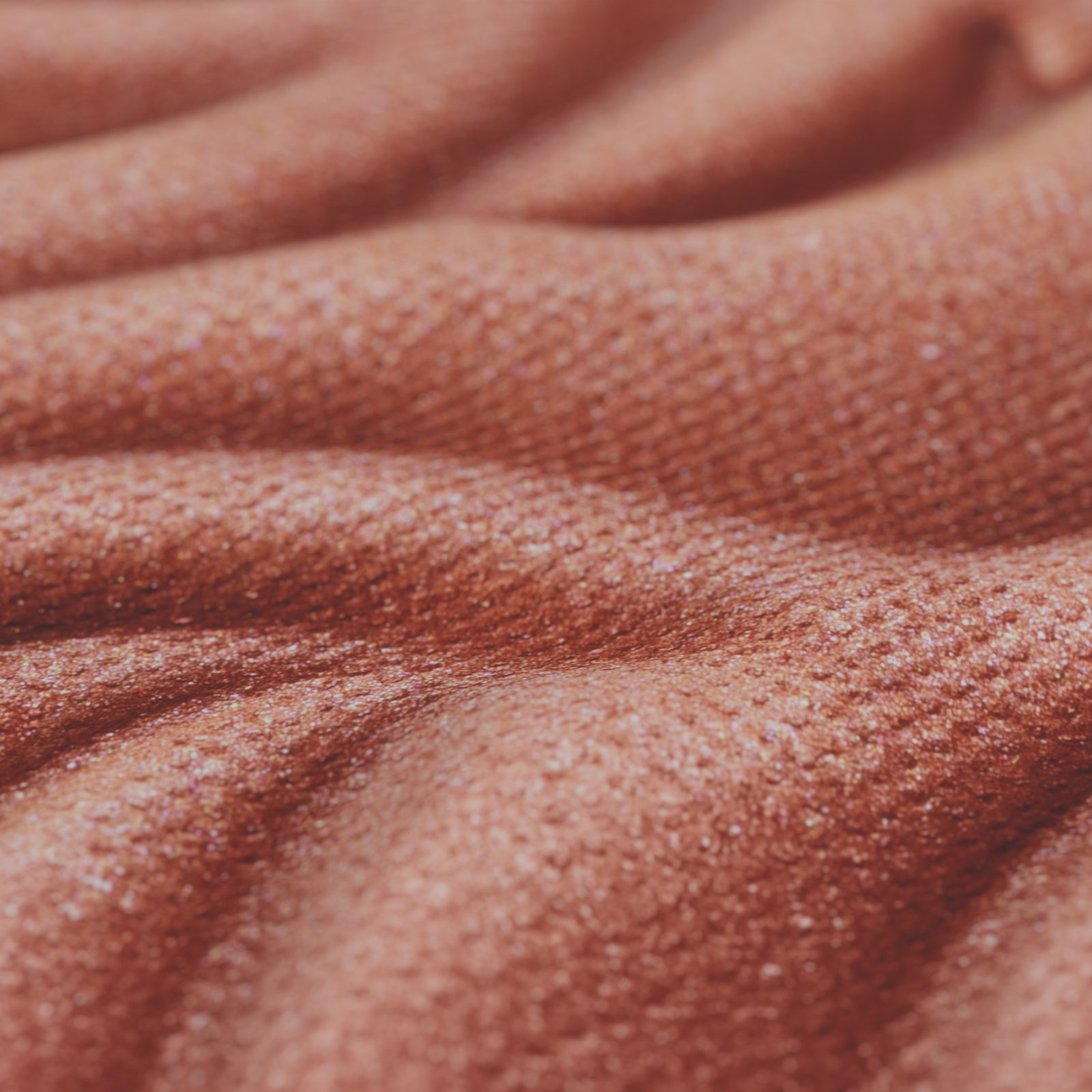 Ultra-macro shot of a textured pressed-powder surface, every grain catching the light